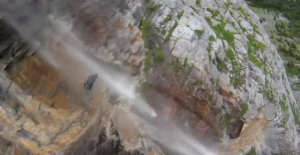 Wingsuit stuntman over waterfall