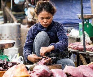 Street Photography in Phnom Penh, Cambodia by Tim Kelsall - woman working in Psar Chas Old Market